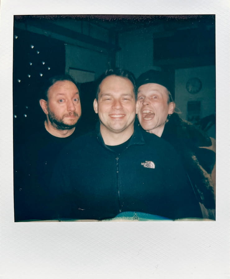 The three men of the band Forkalyst being silly, looking into
      the camera.