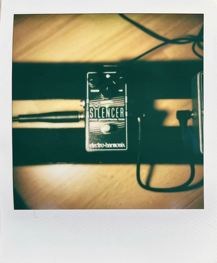A photo of the EHX Silencer pedal on a pedalboard.