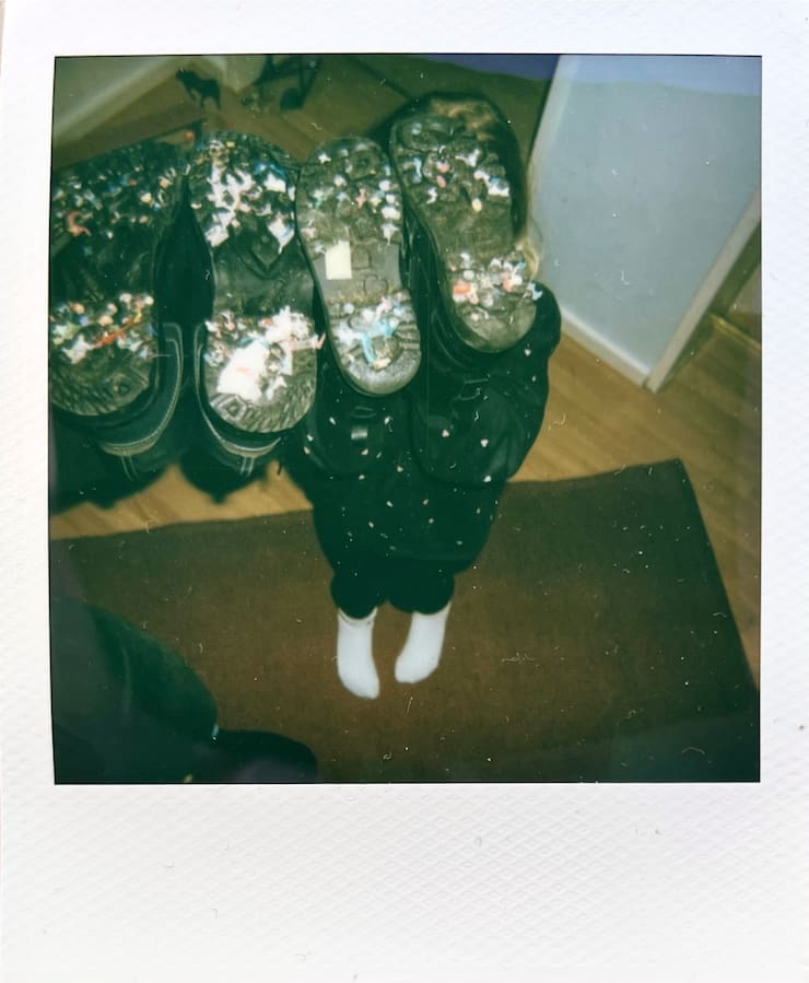 Holding the soles of our shoes into the camera, you can see lots of confetti and other colourful stuff on there.