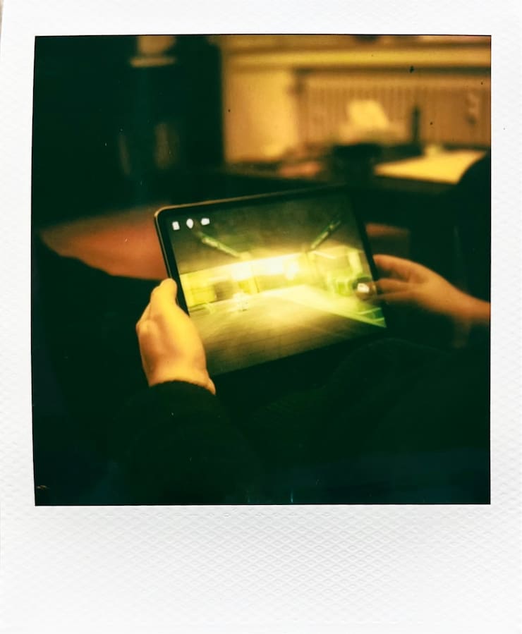 Holding my iPad with both hands in my lab, playing the game
      