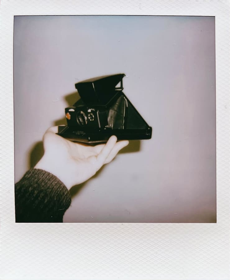 A photo of my SX-70 camera in my hand.