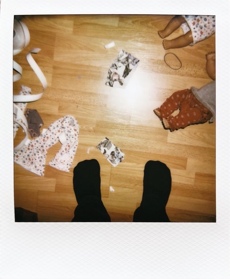 Colour photo of a wooden floor covered in toys.