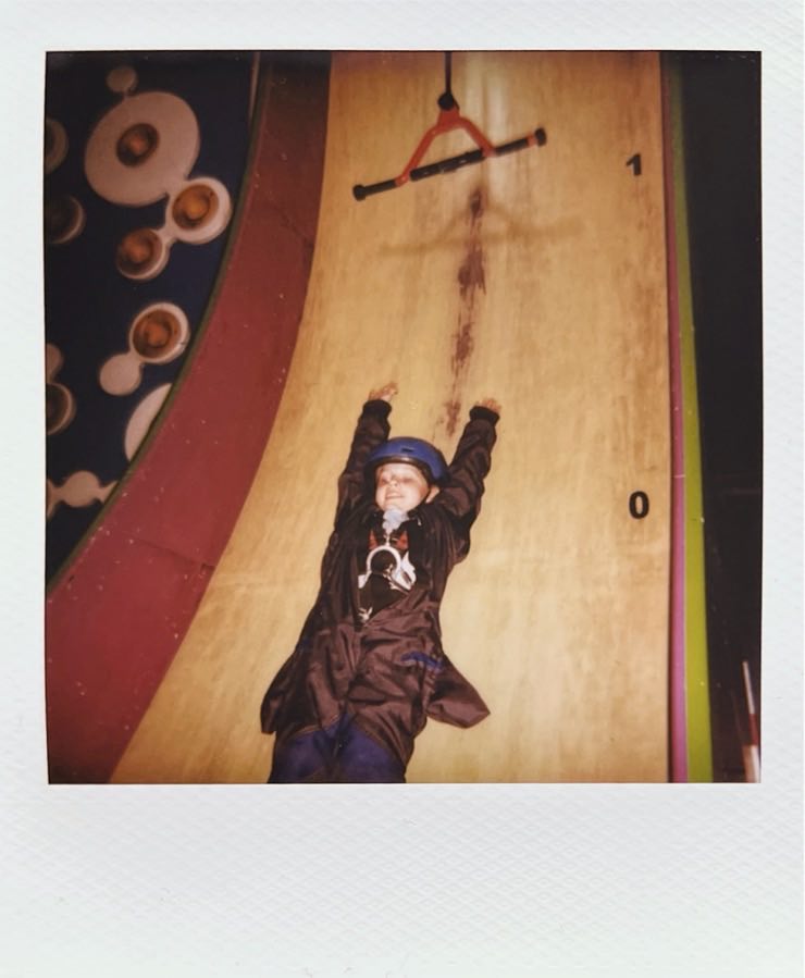 A child sliding down a slide.