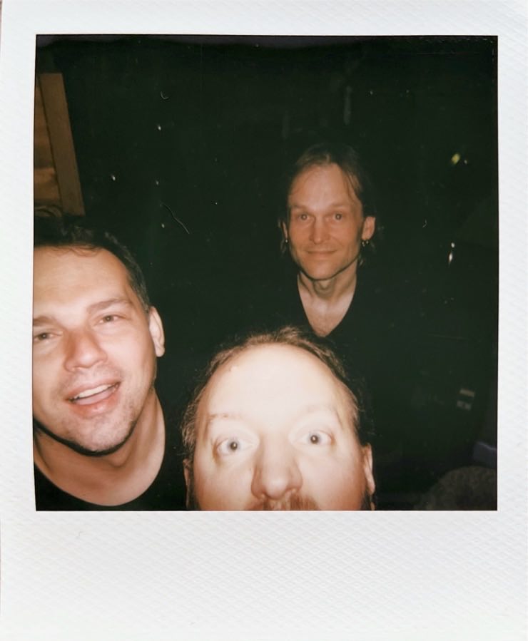 The three men of Forkalyst looking up into the camera.