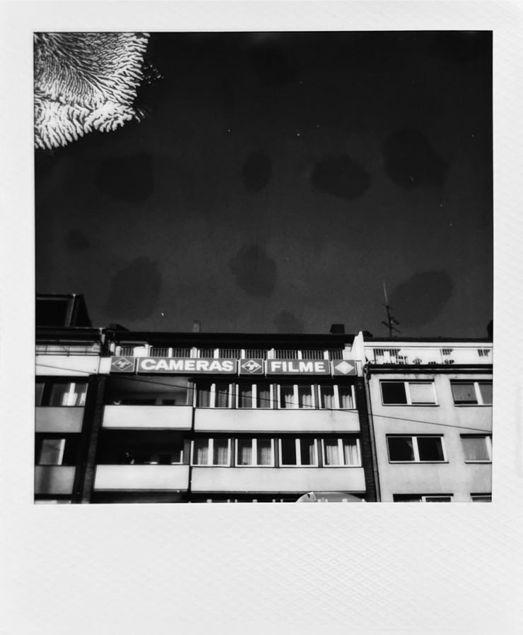 A building with old-school advertising saying Cameras and Filme.
