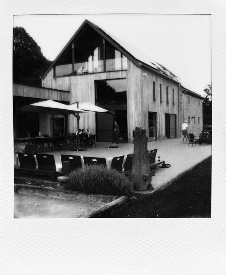 A big wooden house and a large terrace.