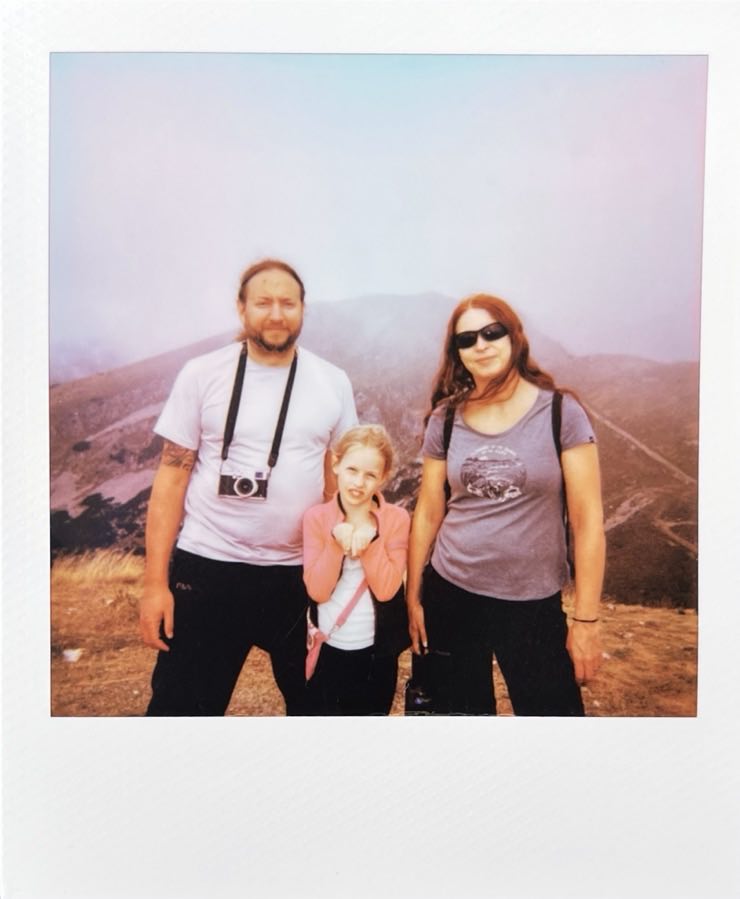 Our family of three with a mountain in the background.