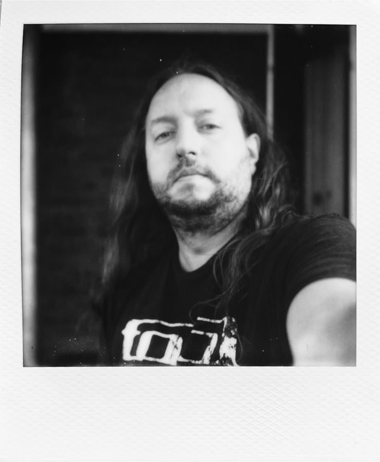 Me taking a black and white selfie, holding the camera.